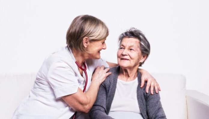 Studio portrait of a senior nurse and an elderly woman.