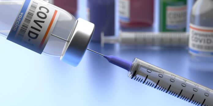 Coronavirus Covid 19 Vaccination. Medical injection syringe and vial with vaccine