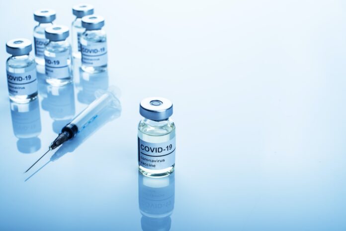 Glass sealed vials with coronavirus vaccine text on label