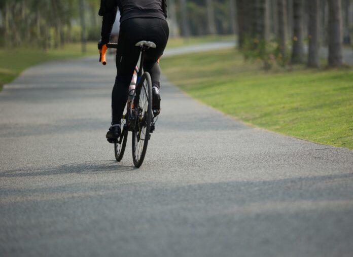 Woman cycling in tropical forest Woman cycling in tropical forest