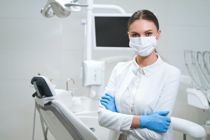 Young female dentist in clinic stock photo