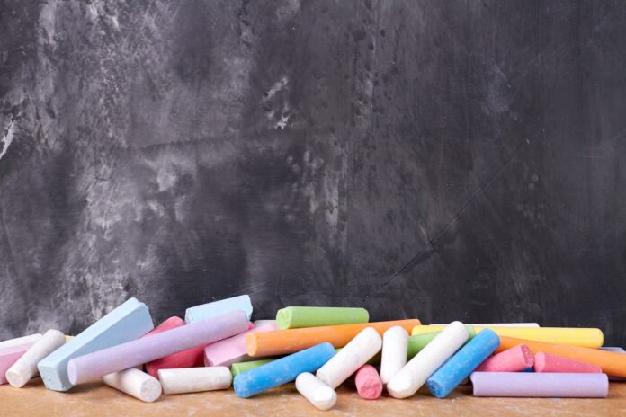 Colorful chalks near the blackboard.