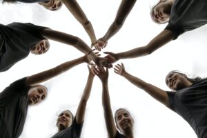 Confident all-female soccer team huddle before a soccer game