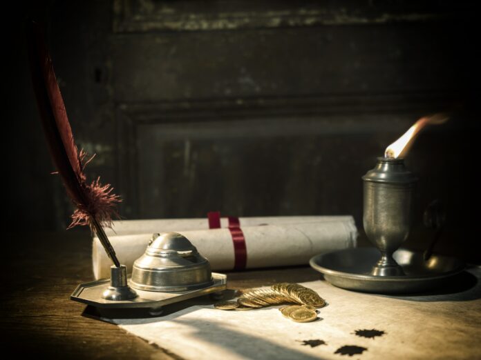 Antique parchment paper sheets lit by candlelight Antique parchment paper sheets lit by candlelight